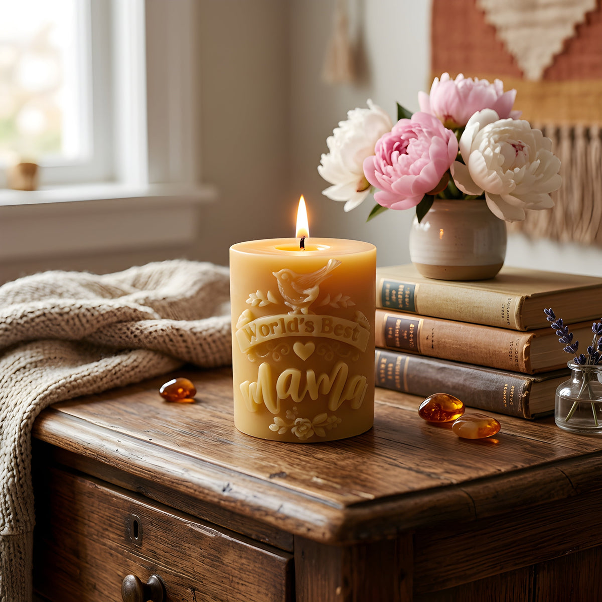 Honey-colored beeswax candle with embossed mother and flower design, lit flame