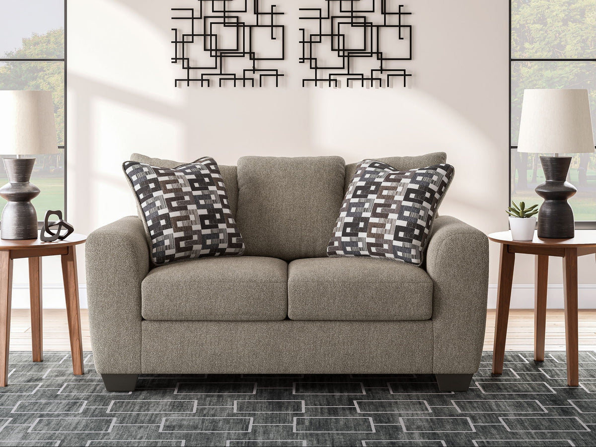Beige fabric sofa set with two armchairs and black-and-white geometric throw pillows
