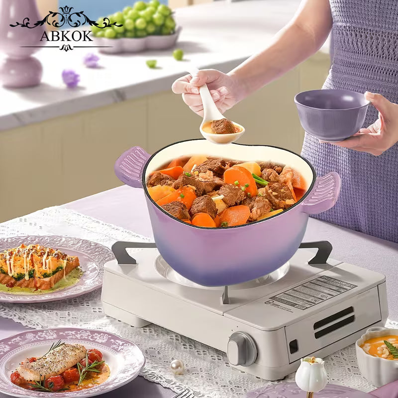 Purple enamel cast iron Dutch oven on a stovetop with food inside and side handles