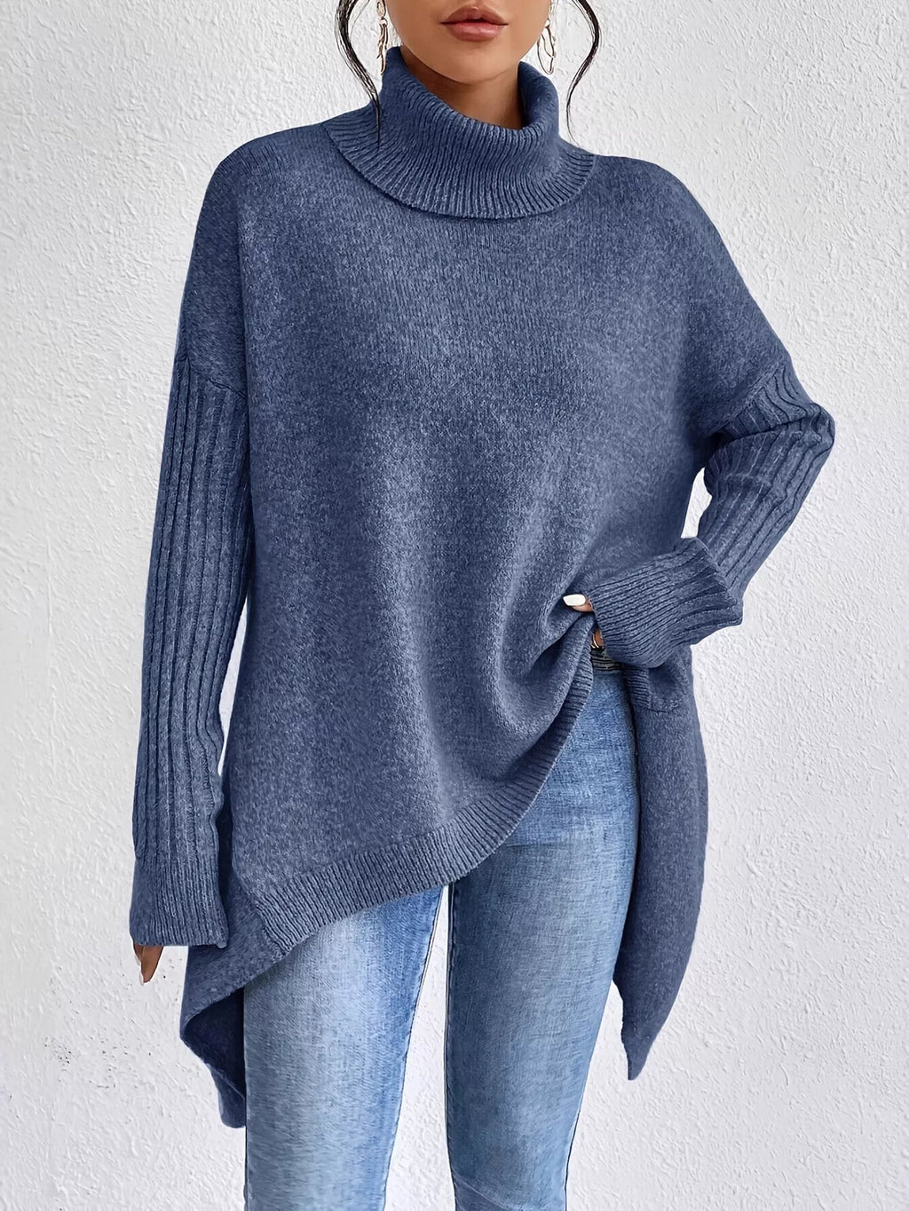 Navy turtleneck sweater with ribbed cuffs, long sleeves, and high-low hem