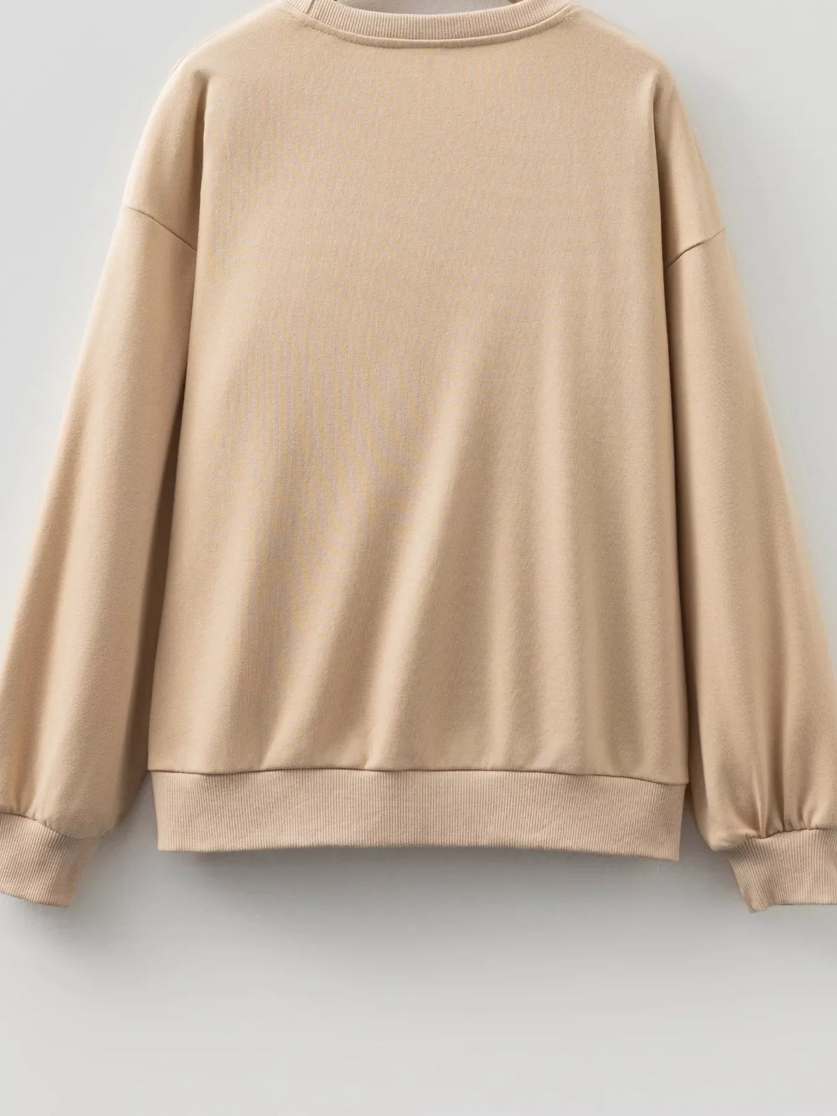 Beige drop-shoulder sweatshirt with plain back and ribbed hem