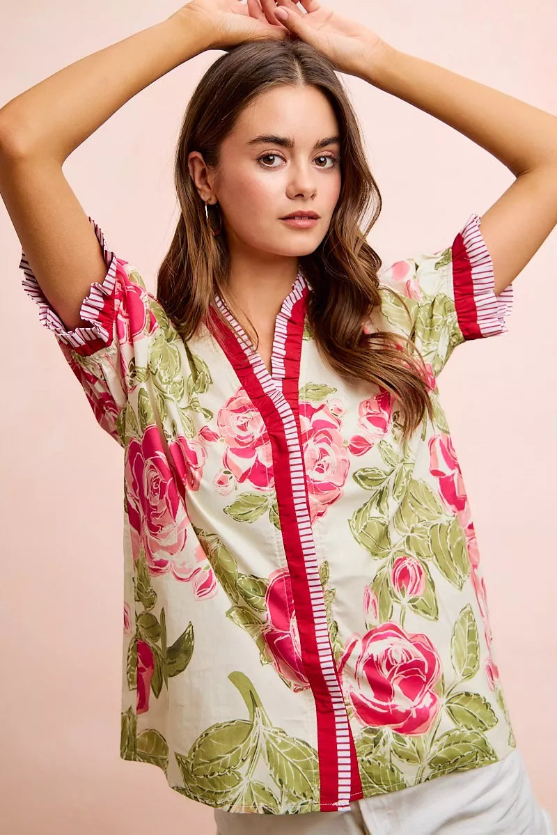 Floral printed woven blouse with coral contrast trim and ruffled sleeves