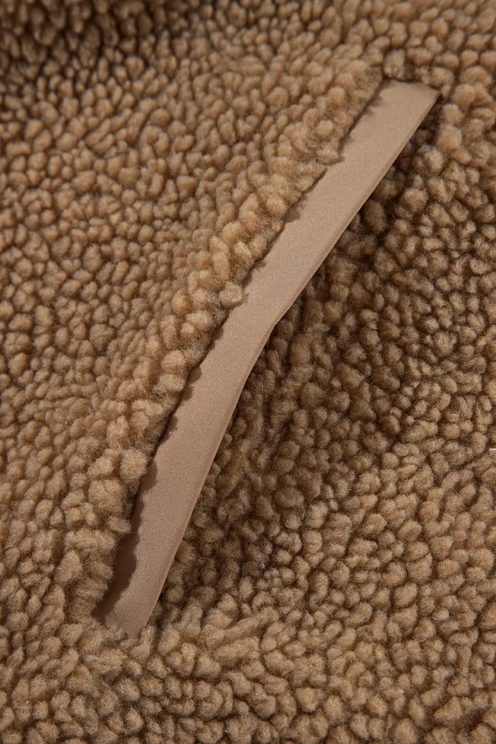 Khaki fleece jacket front edge with zipper placket lining, close-up
