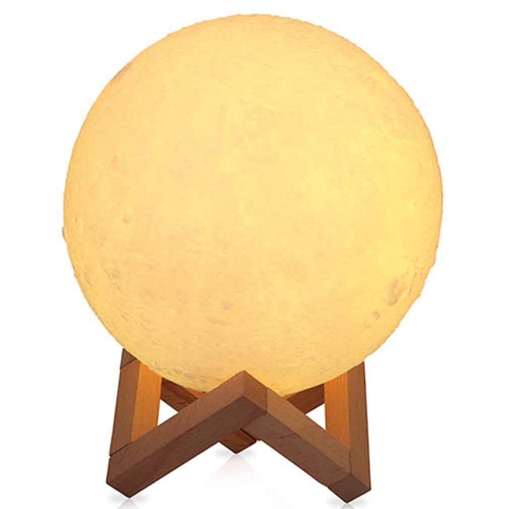 Globe night light with yellow glow and light wood tripod stand