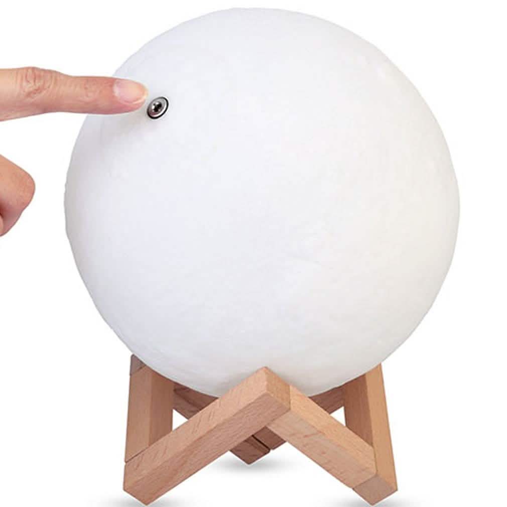 White globe night light with light wood tripod stand