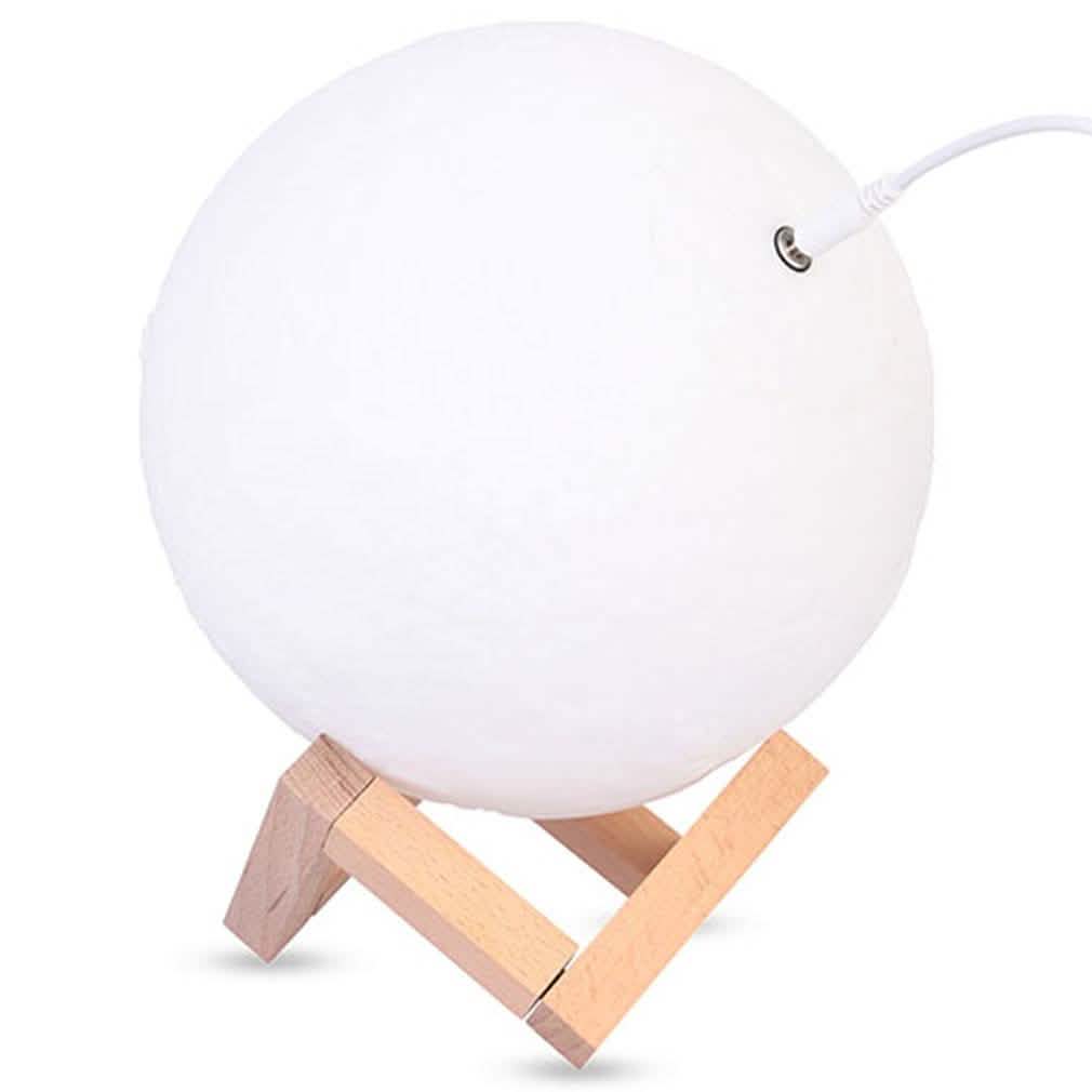 White globe night light on light wood tripod stand with power cord