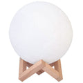 White globe night light with light wood tripod stand