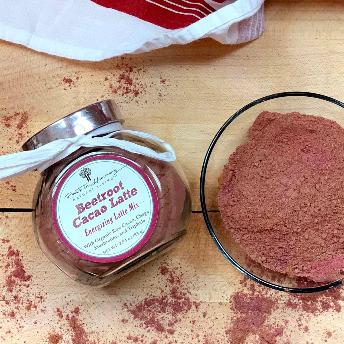 Beetroot cacao latte mix bottle and a glass bowl filled with pink powder