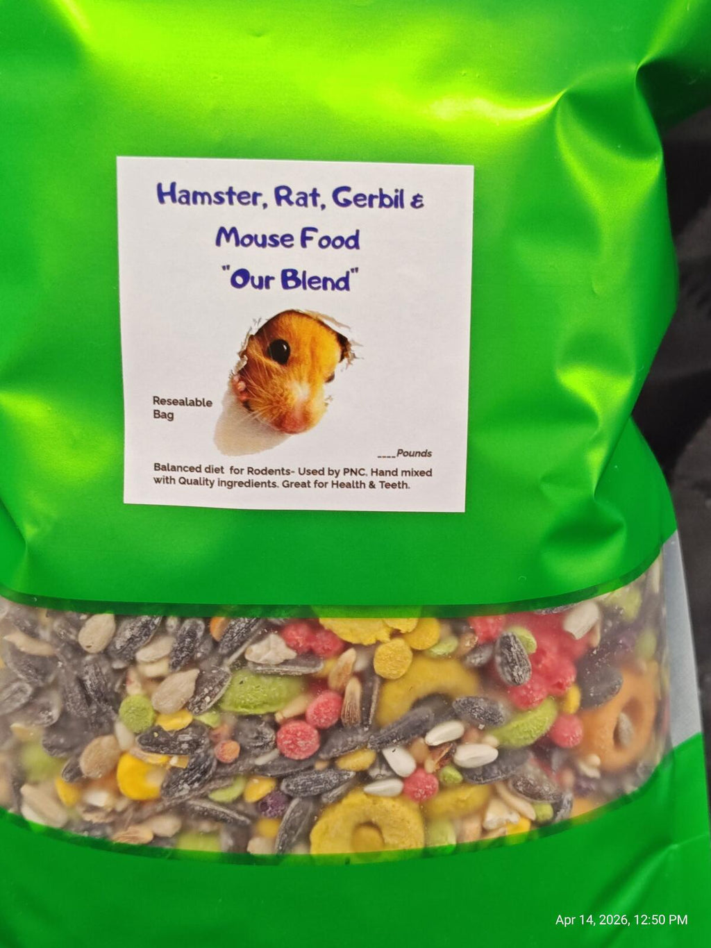 Close-up of green rodent food pouch label with visible mixed kibble below.