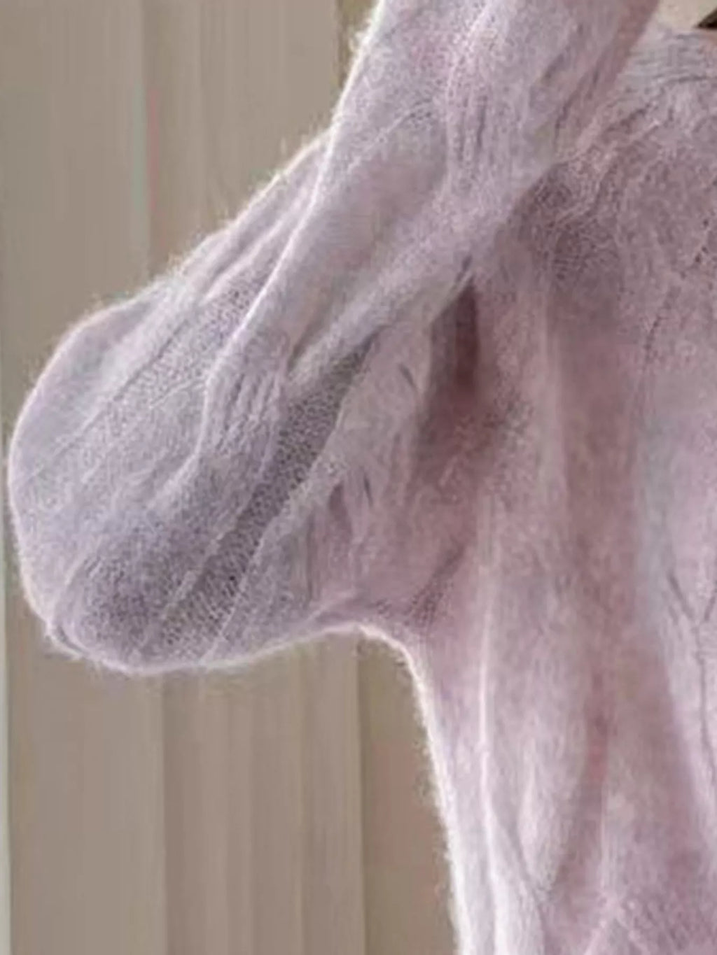 Pink cable-knit sweater sleeve with ribbed cuff
