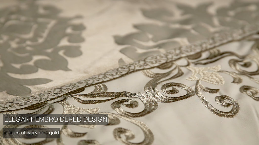 Ivory comforter ensemble border in gold with decorative embroidered scroll pattern