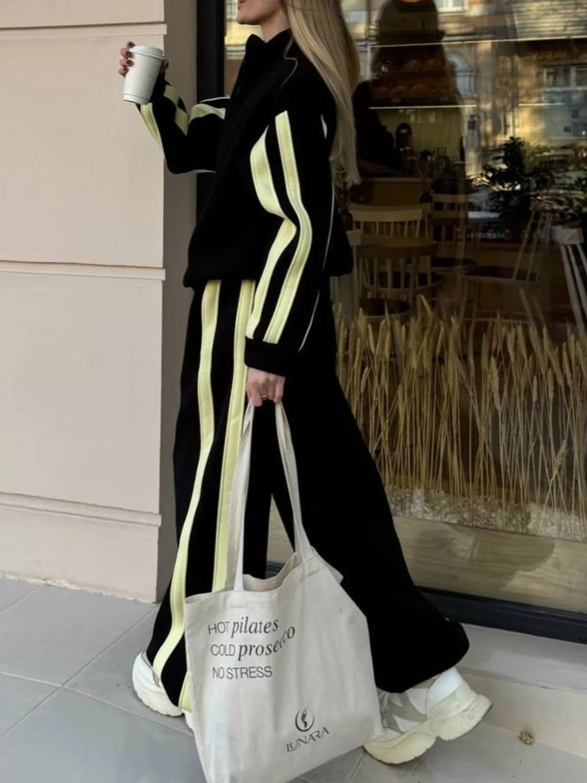 Black contrast-striped zip-up top and wide-leg pants set with lime side stripe details.