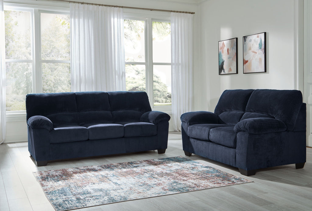 Navy sofa and loveseat set with rounded arms, tufted cushions