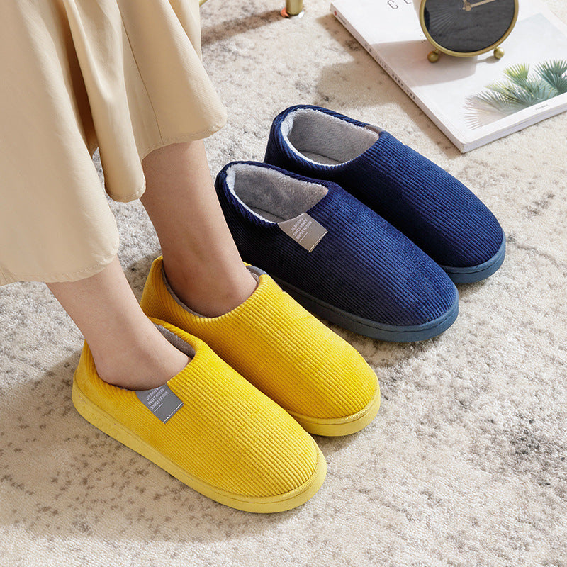 Navy and yellow corduroy slip-on slippers with gray fuzzy lining and flat rubber sole.