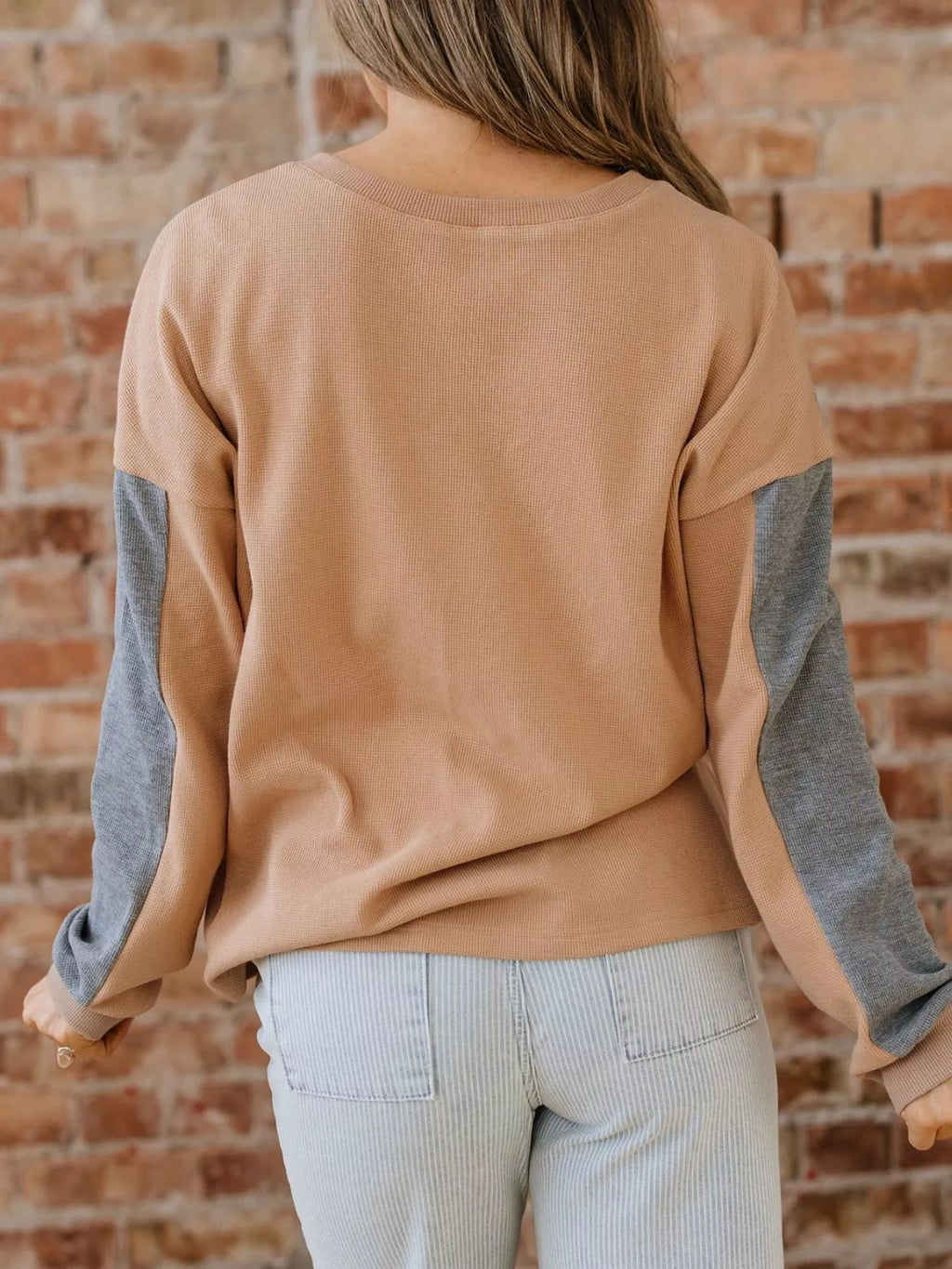 Back view of color block thermal henley top in camel with green and gray sleeves