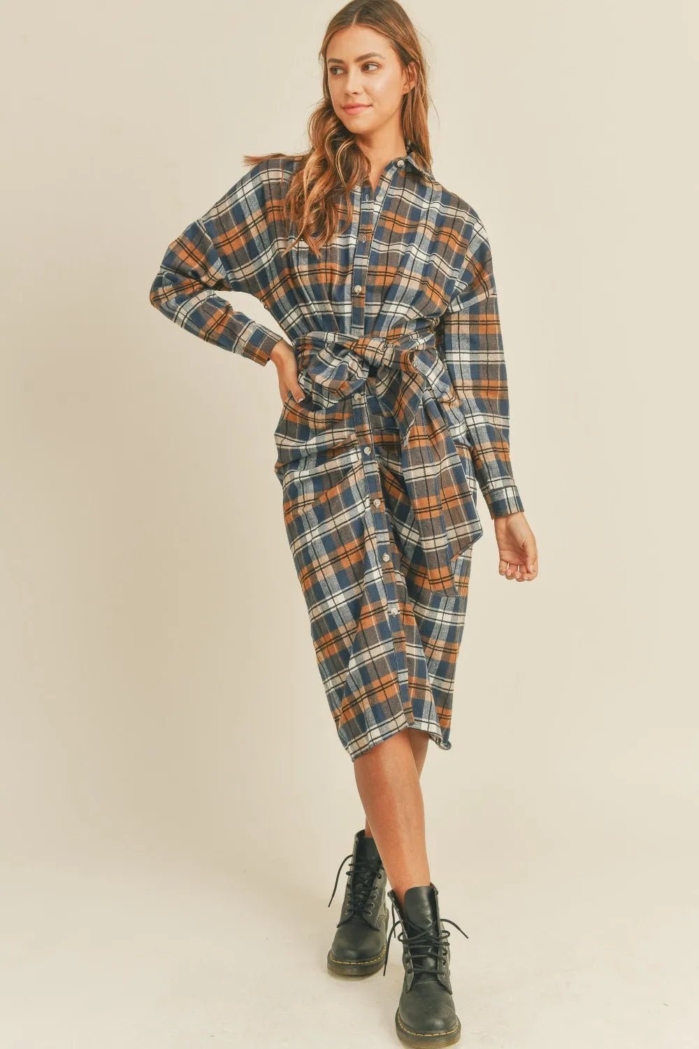 Plaid flannel shirt dress with button front and waist tie belt, front side view