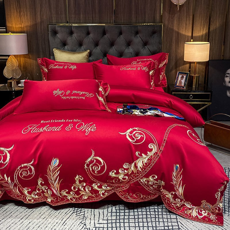 Red quilted bed sheet set with gold ornate embroidery and matching pillowcases