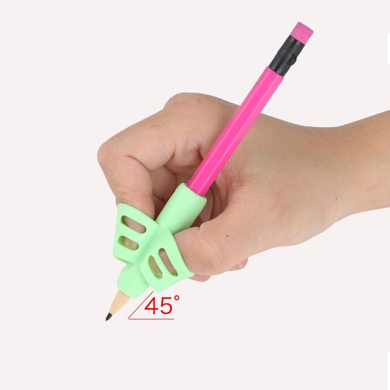 Child hand holding a pink pen with mint green triangular finger grip