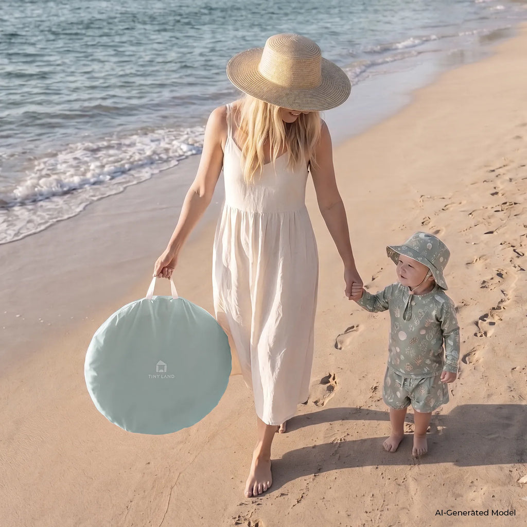 3-in-1 baby beach tent with green round carry bag on sand