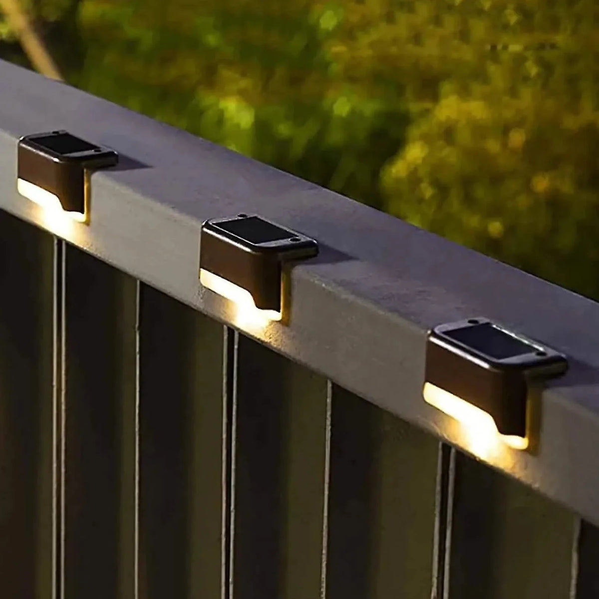 4-pack solar deck step lights, black housings with warm white glow