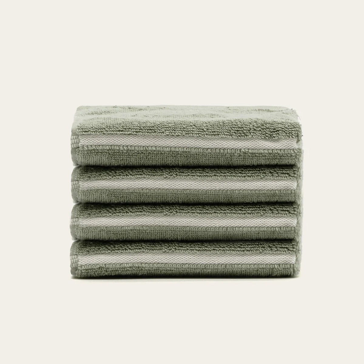 Cotton towel set in sage green, stack of folded bath, hand, and wash towels