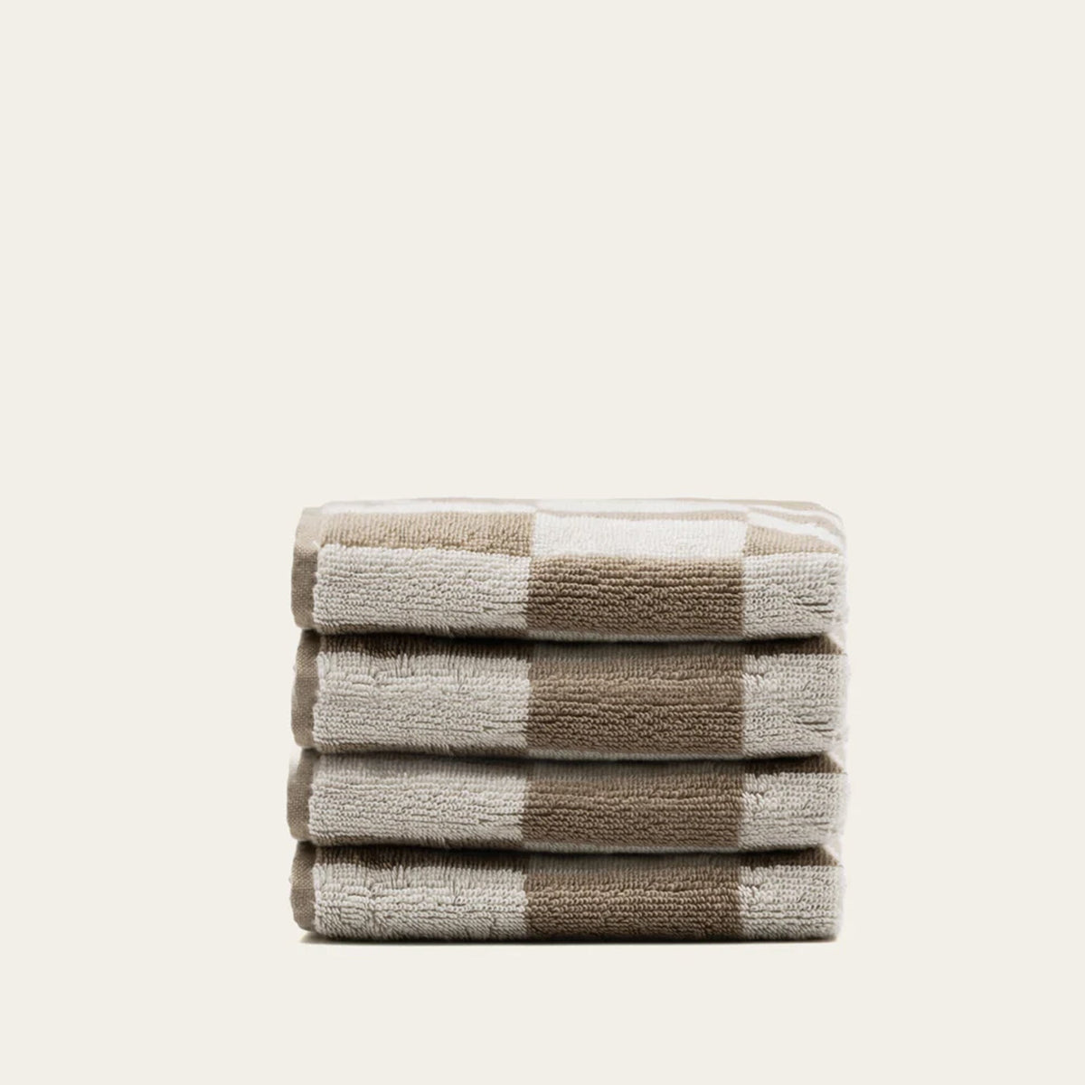 Folded Australian cotton bath towel in ecru with tan stripe-and-check pattern
