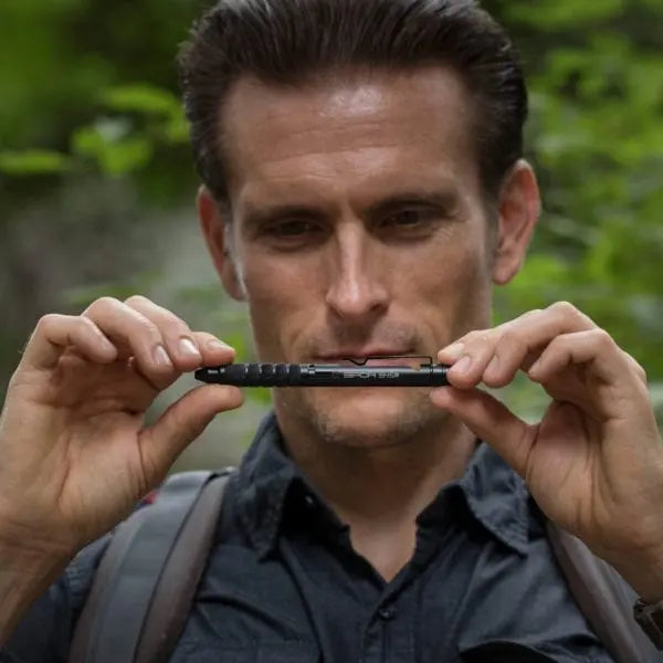 Bolt-action EDC pen held by hands, front profile