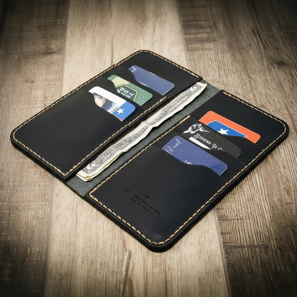 Black long leather wallet opened with card slots and bill compartment, stitched edges.