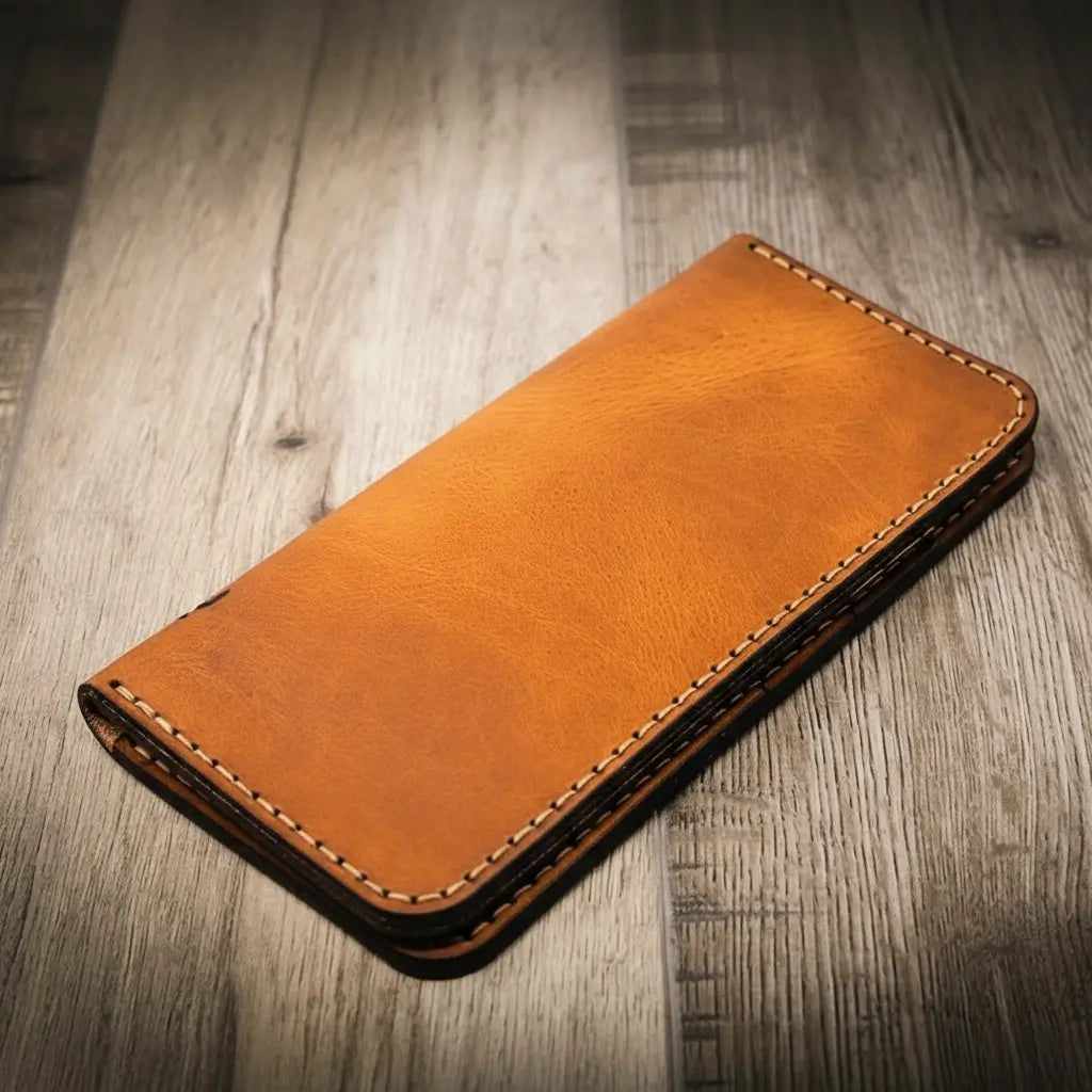 Orange-brown long leather wallet with smooth front and stitched border.