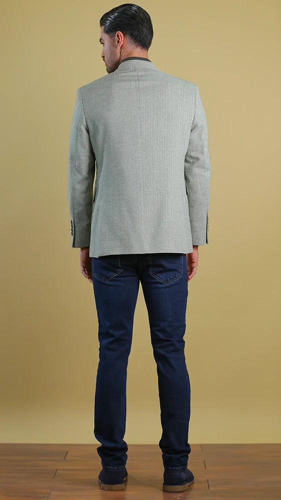 Back view of single-breasted olive-toned blazer with two-button cuffs