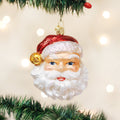 Santa face glass ornament with a glittery red hat, gold bell, and white beard