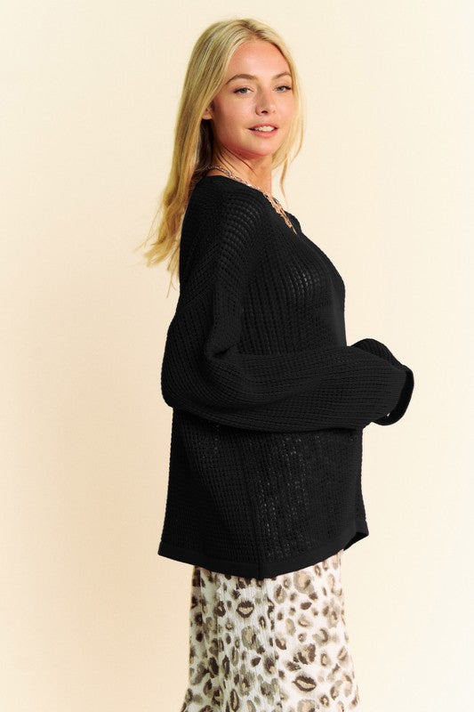 Black star-front crochet knit sweater in side profile with drop-shoulder sleeves