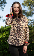 Leopard print button-up shirt with red contrast cuffs and collar