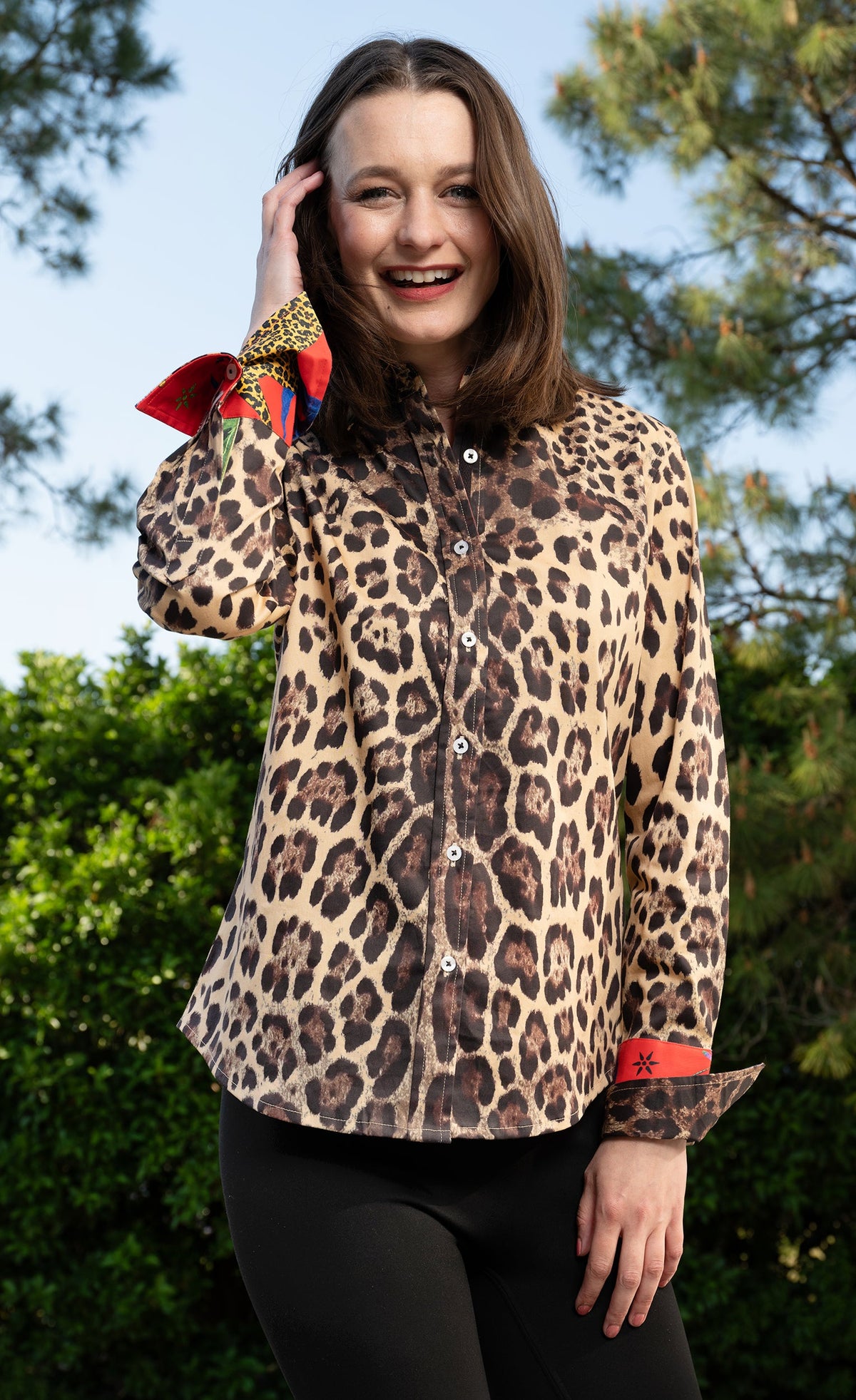 Leopard print button-up shirt with red contrast cuffs and collar
