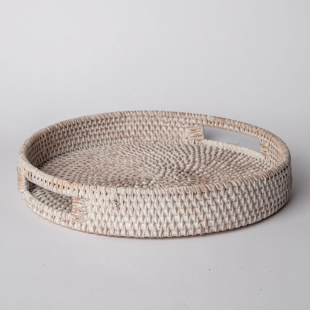 Round woven rattan tray with white finish and raised rim, empty