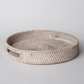 Round woven rattan tray with white finish and raised rim, empty
