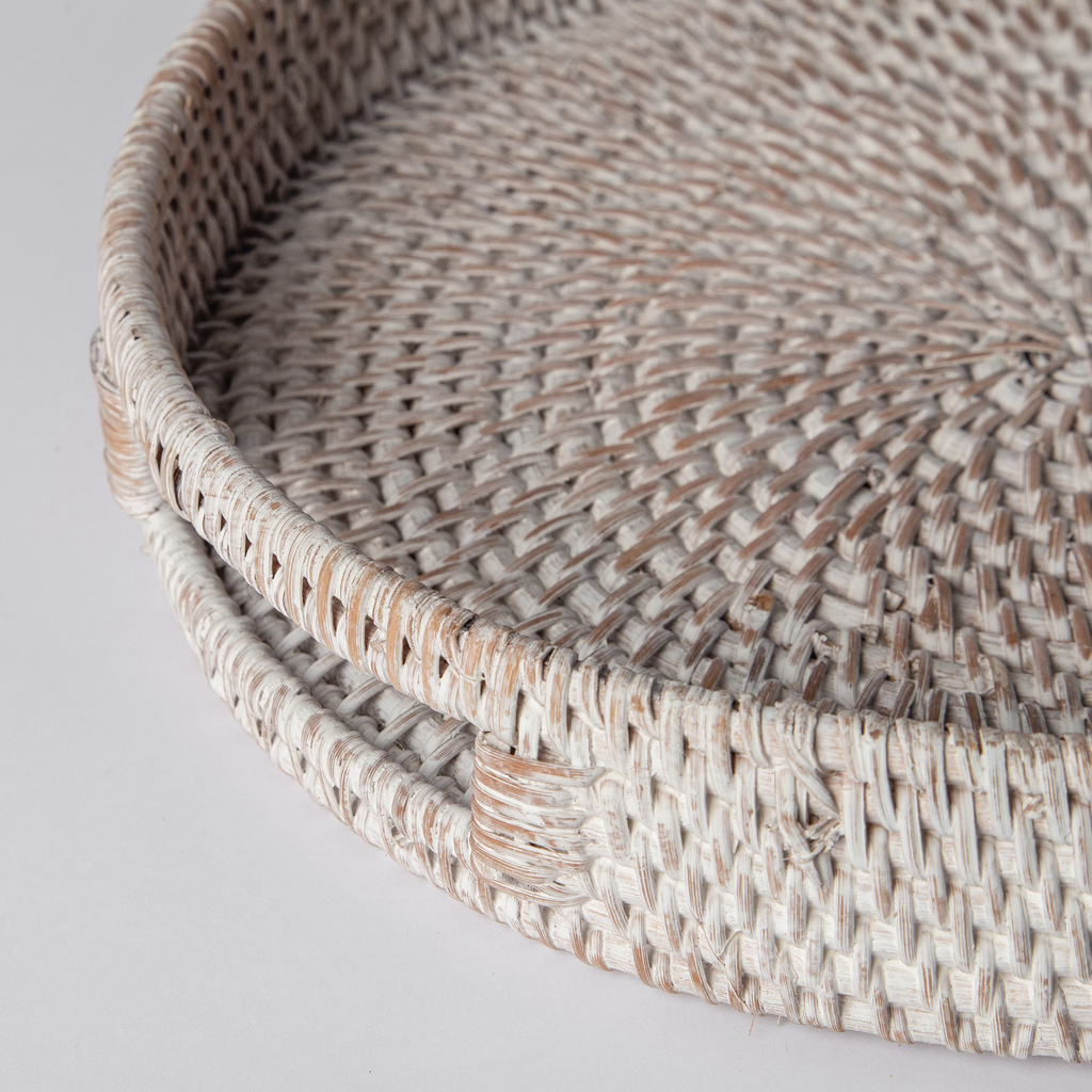 Close-up of round rattan tray weave with white and natural tones, shallow rim