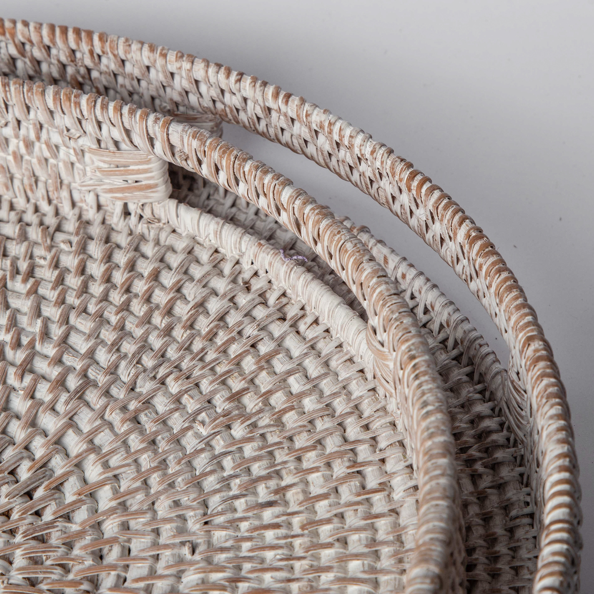 Rattan tray interior with tightly woven pattern and raised outer edge