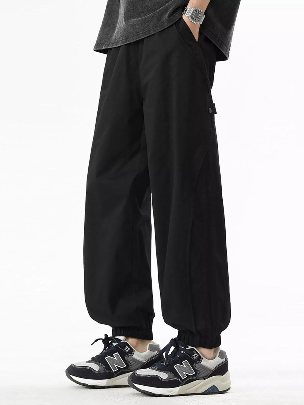 Black loose-fit drawstring casual pants, elastic waistband, side pockets, ankle cuffs