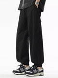 Black loose-fit drawstring casual pants, elastic waistband, side pockets, ankle cuffs