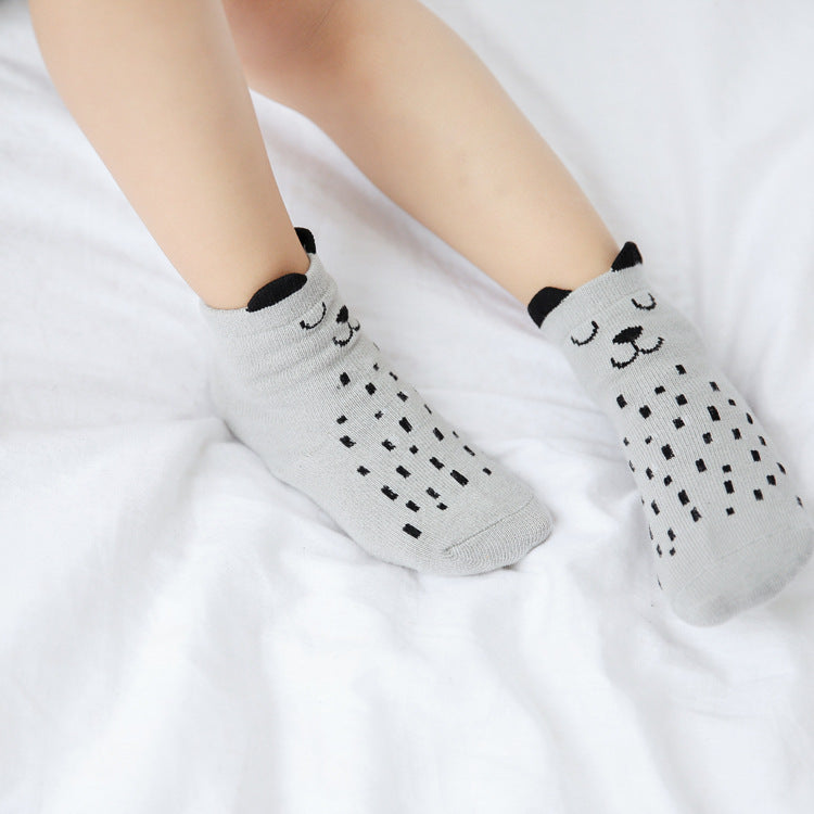 Light gray kids cotton baby socks with panda faces and dotted patterns near the toes.
