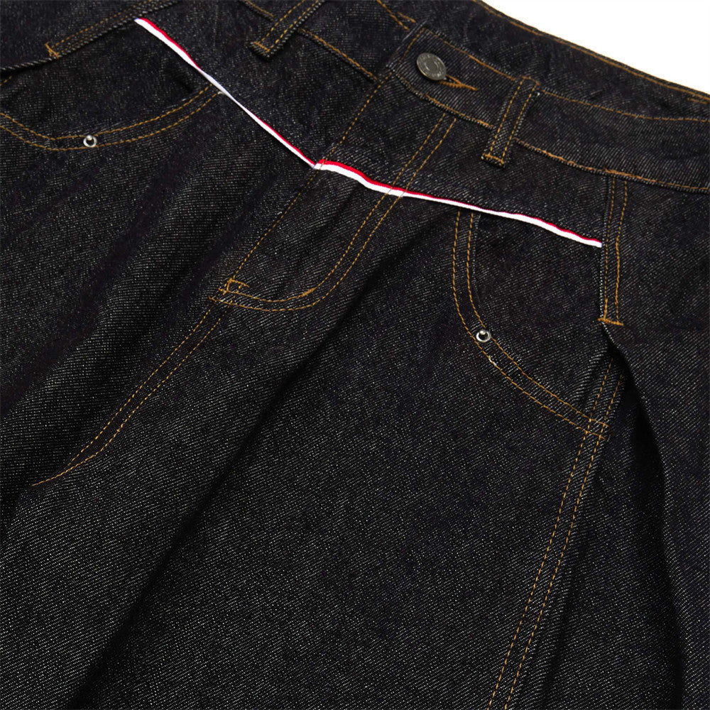 Denim waistband and front fly with pleats, red stripe detail, and metal button
