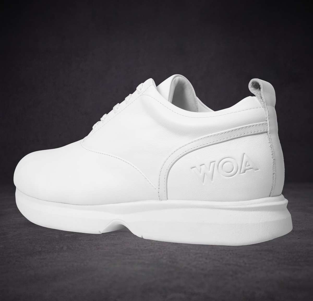 White lace-up sneaker with padded collar and WOA logo heel panel