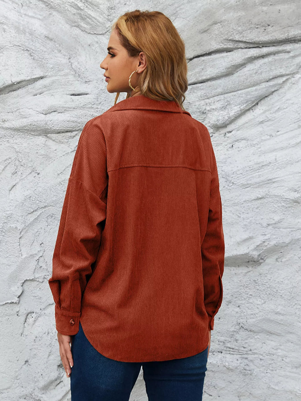 Burnt orange corduroy button-up shirt from back with collar and yoke seam