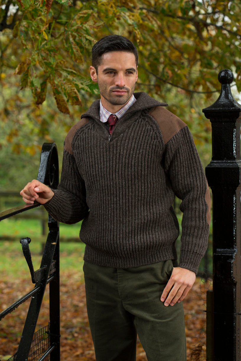 Charcoal quarter-zip knit sweater with brown shoulder and elbow panels, ribbed cuffs.