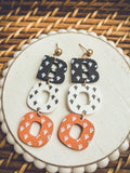 Halloween letter B earrings with black, white, and orange heart patterns