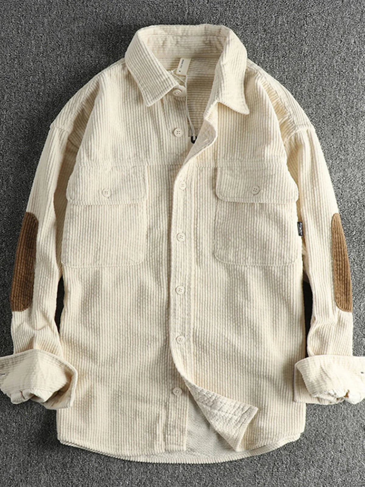 Plus-size corduroy button-up shirt in light beige, with collar, front buttons, and chest pockets