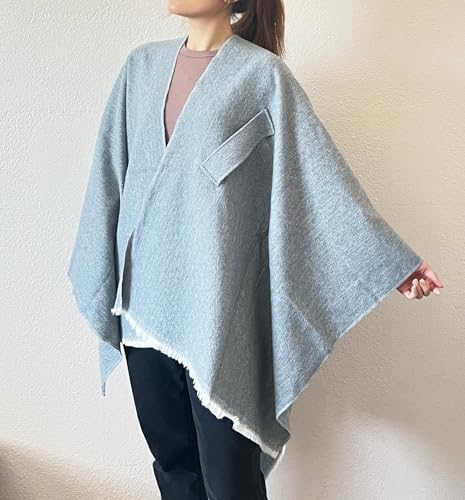 Light gray open-front fringe poncho shawl with angled hem and notch detail