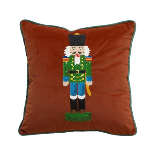 Brown velvet throw pillow cover with embroidered nutcracker figure in green, gold, and red.