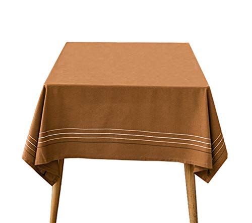 Cotton tablecloth with horizontal stripes and tassel trim, camel-brown woven fabric.